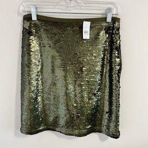 New with tags. Loft. Green/gold sequin mini. Size 2.